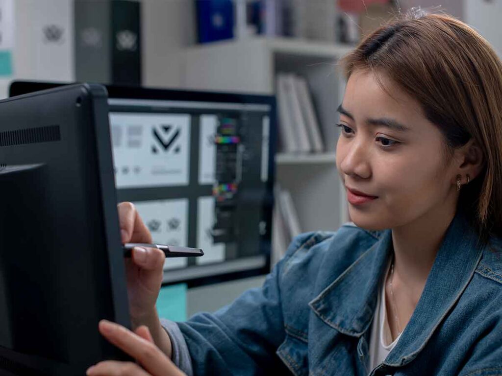 A Woman Using A Stylus On A Computer