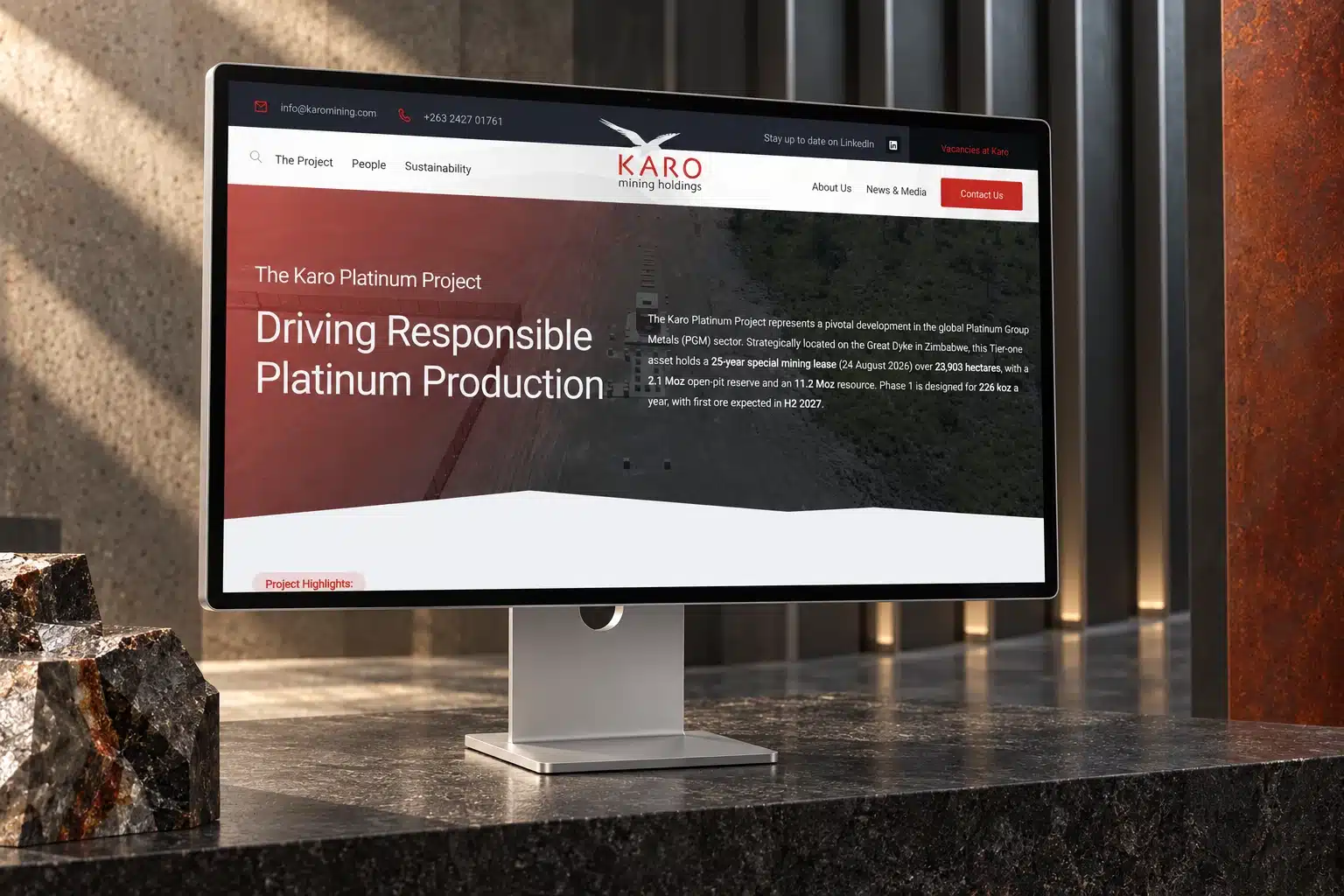 Karo Platinum Project website on an Apple Studio Display in a stone and steel setting