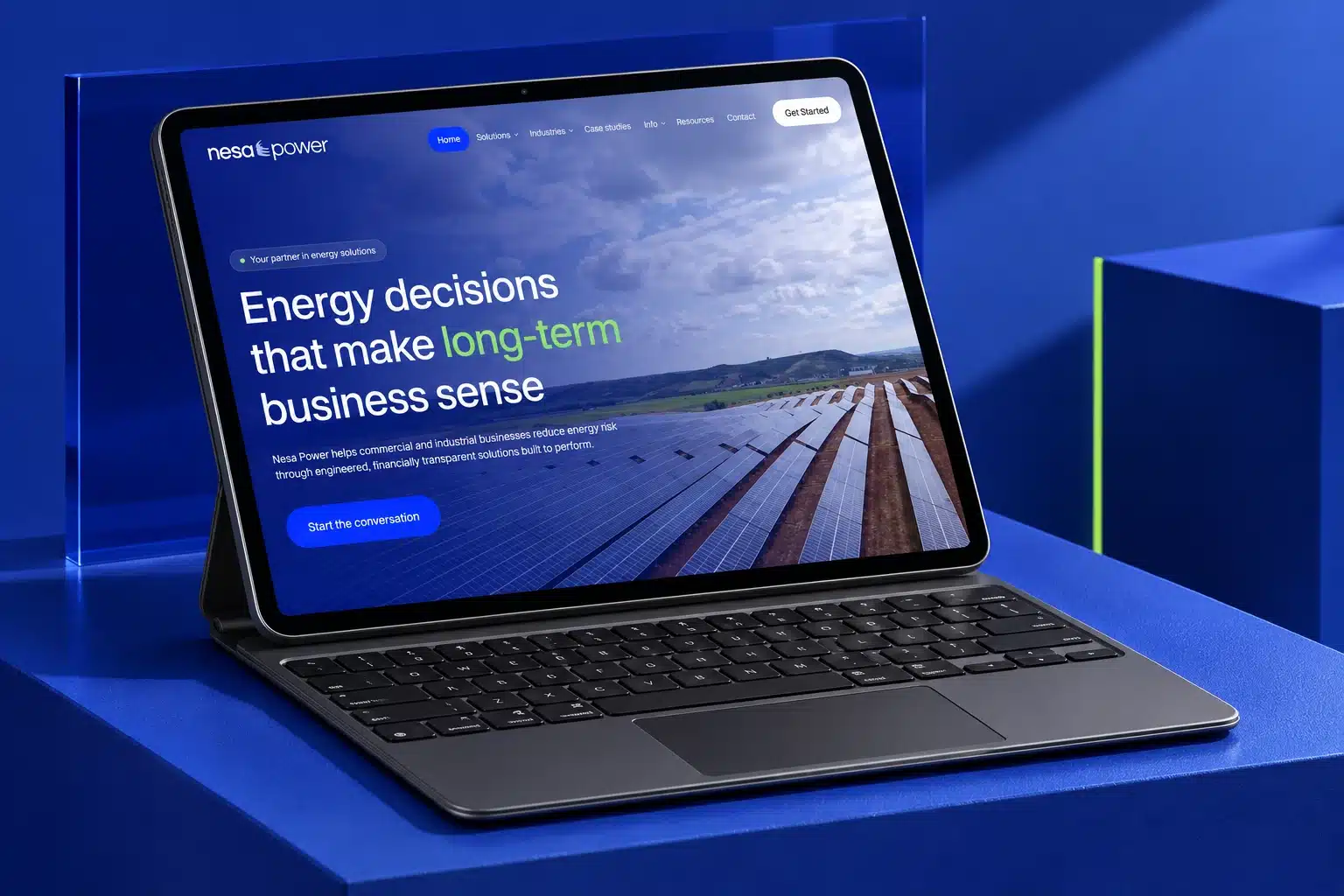 Nesa Power homepage on an iPad Pro with Magic Keyboard on blue architectural plinths