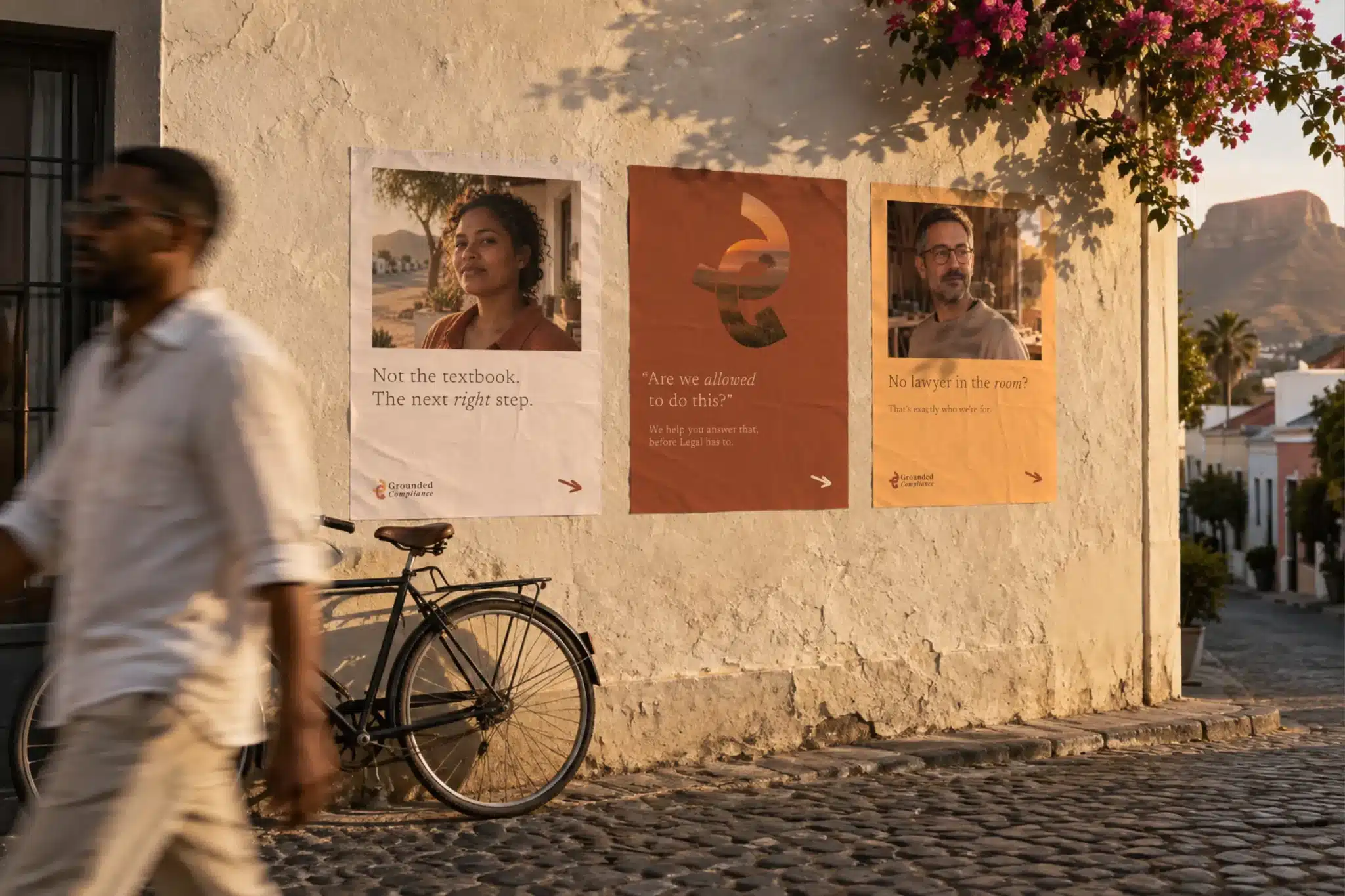 Family of wheat-pasted Grounded Compliance posters on an outdoor wall